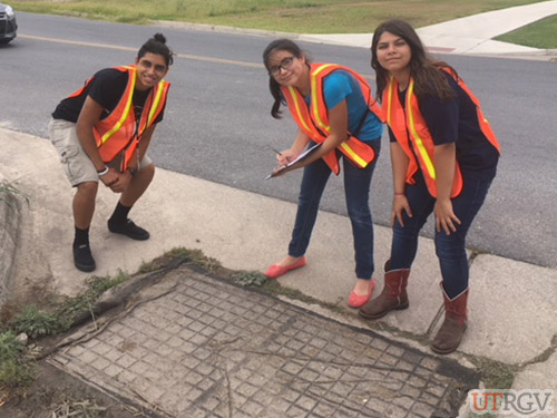 Upward Bound students investigating university storm drains blocked during the recent rain event. June 29, 2018