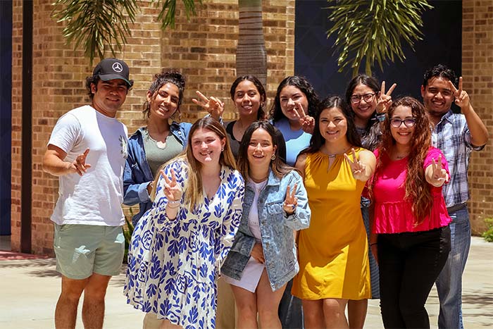 Service learning students outside building.