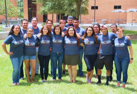 Large group of student volunteers outside wearing Engaged Scholarship & Learning t-shirts.