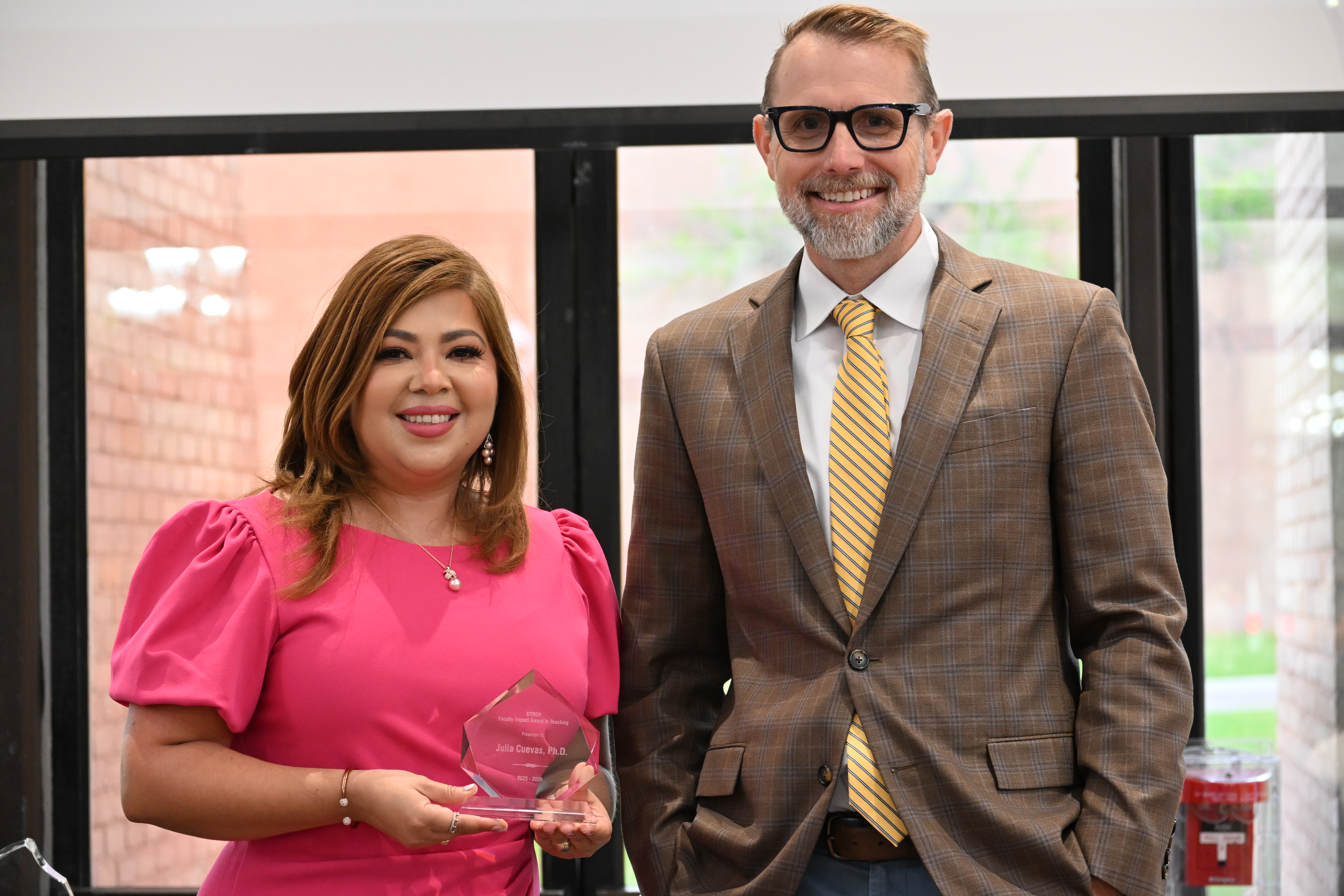 dr julia cuevas posing for a picture with dr dearth with her faculty impact award in teaching