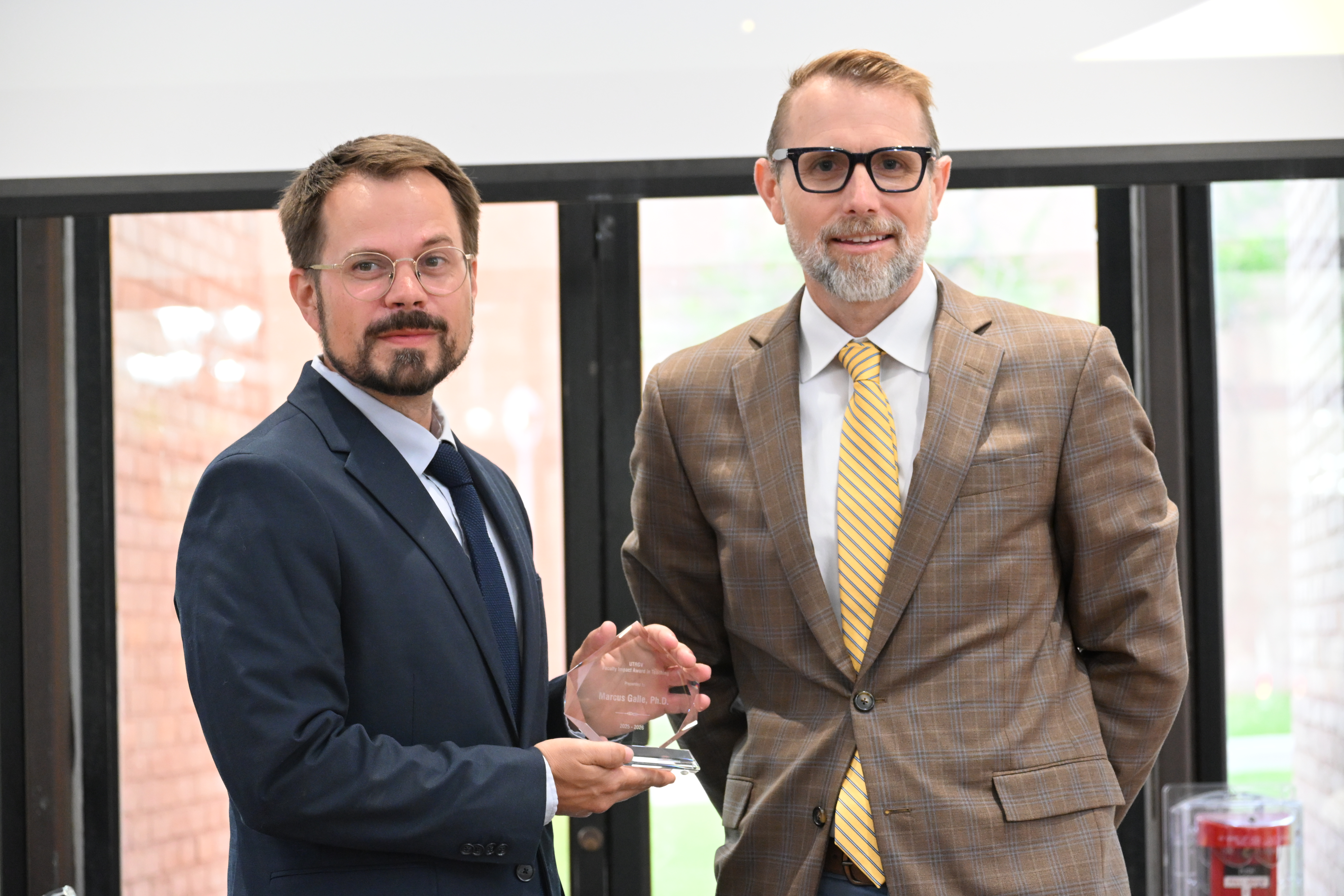 dr galle posing for a picture with dr dearth with his faculty impact award in teaching 