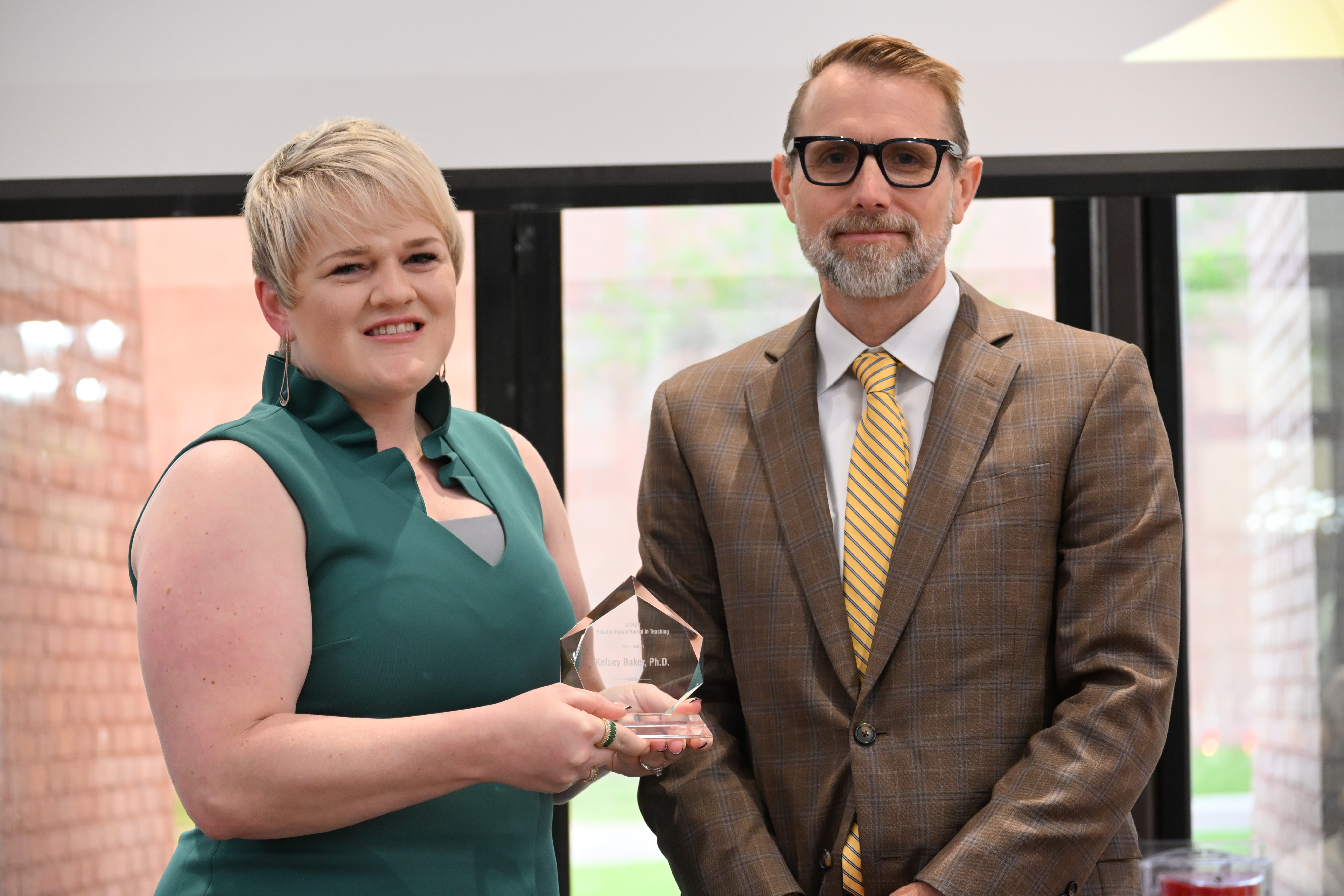 dr kelsey baker posing for a picture with dr dearth with her faculty impact award in teaching