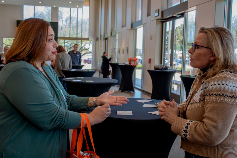 two faculty members talking during the 14 day writing challenge