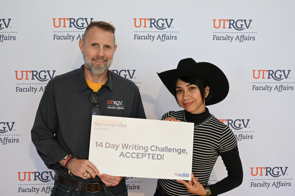 dr dearth and josie posing with a poster that says 14 day writing challenge accepted