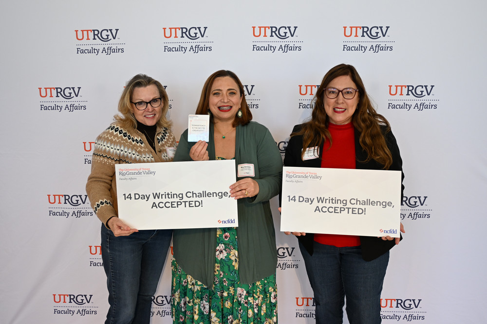faculty members posing for a group photo with the poster that says 14 day writing challenge accepted