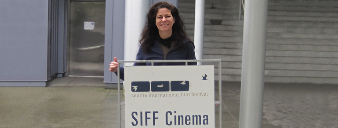 Dr. Belau holding SIFF Cinema sign