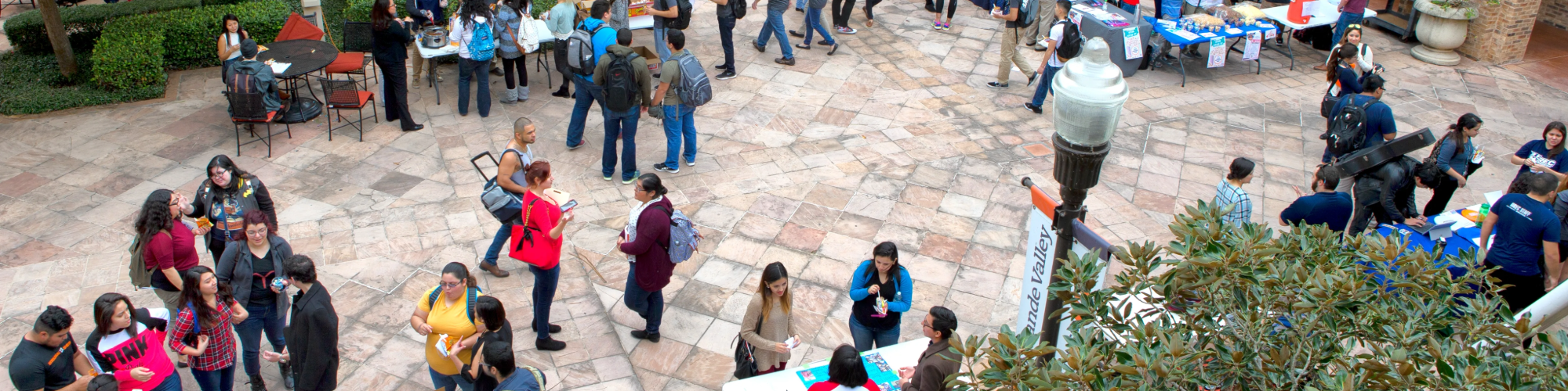 Aerial image of students outside on campus at different organization's tables.