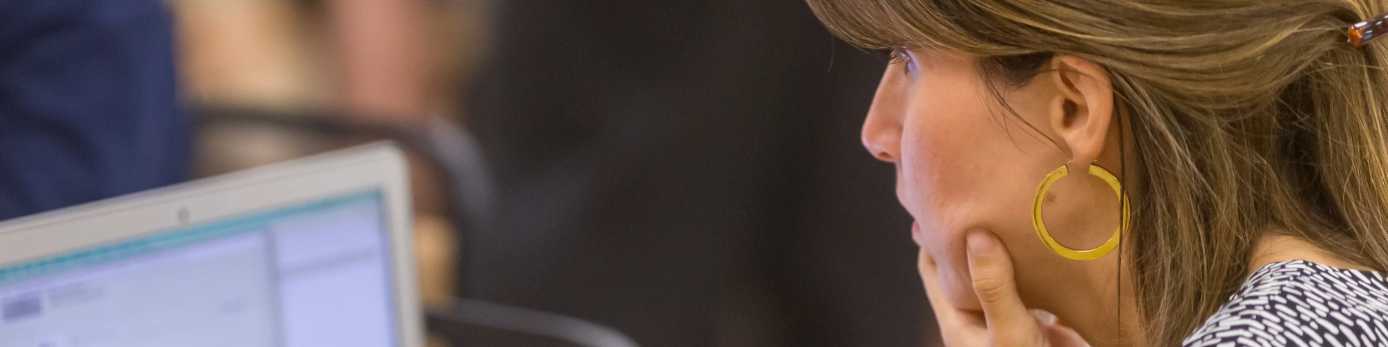 Supervisor sitting and working on laptop.