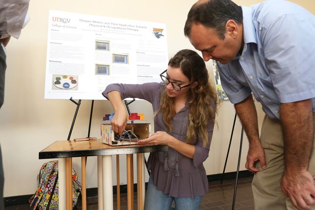student showing off research project