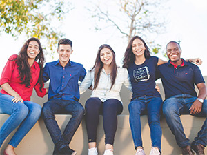 Group of students happily sitting in bench