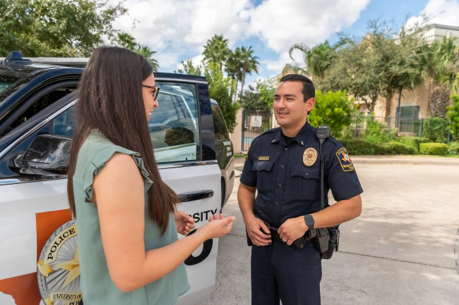 student speaking with campus police officer