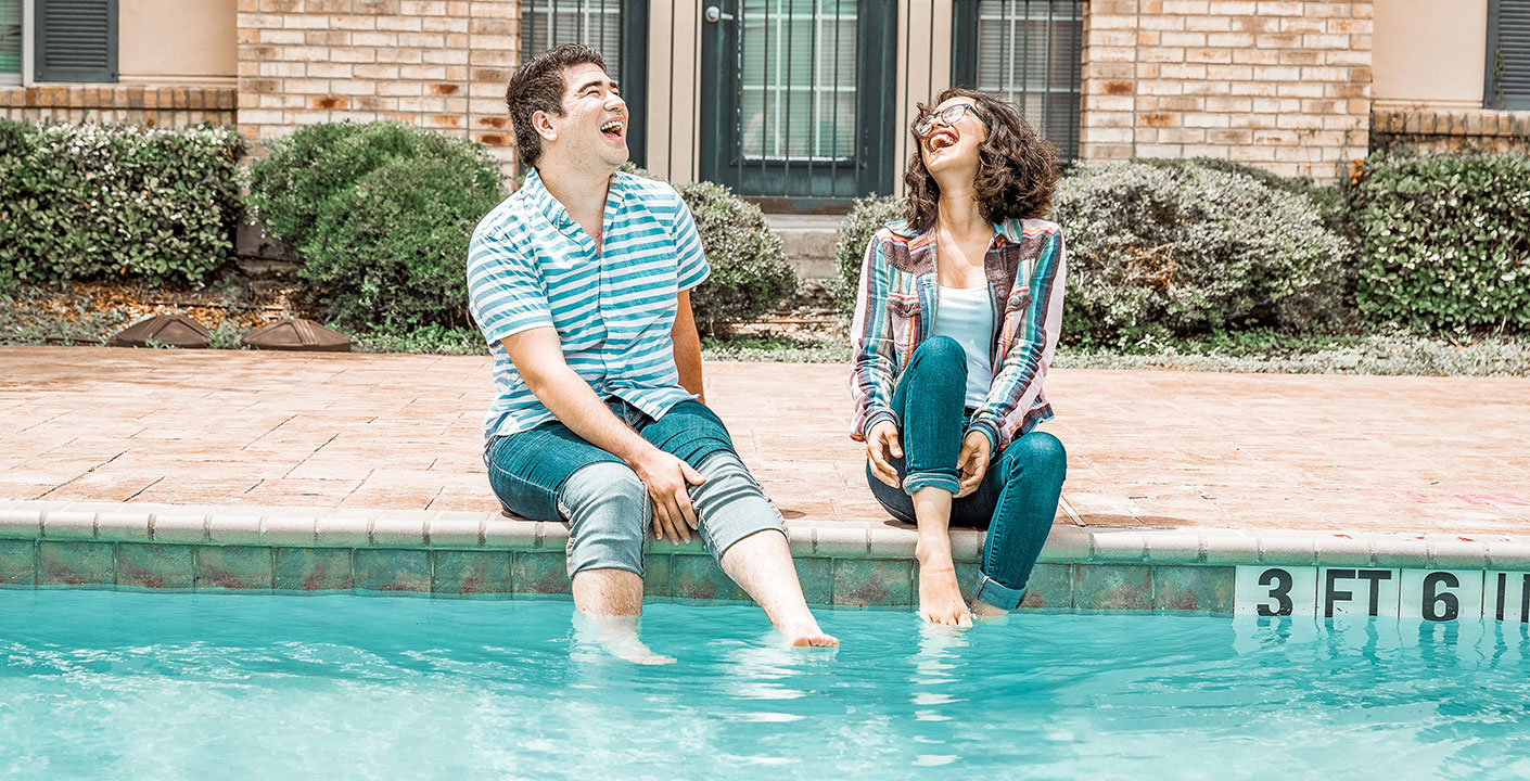 Two students chatting by the pool at Casa Bella.