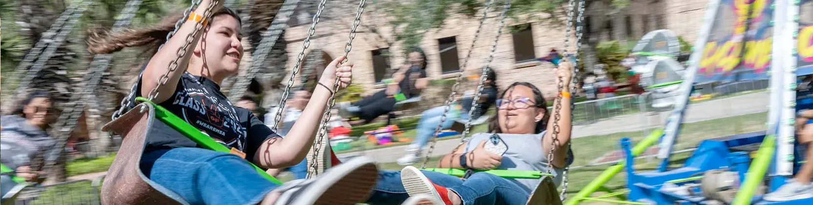 students enjoying mechanical rides on campus