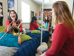 A group of friends having a good time in their dorm at Casa Bella. 