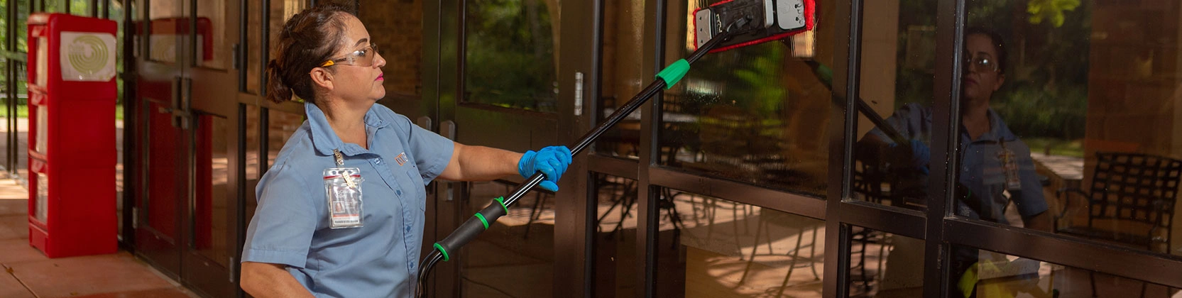 Maintenance worker cleaning windows