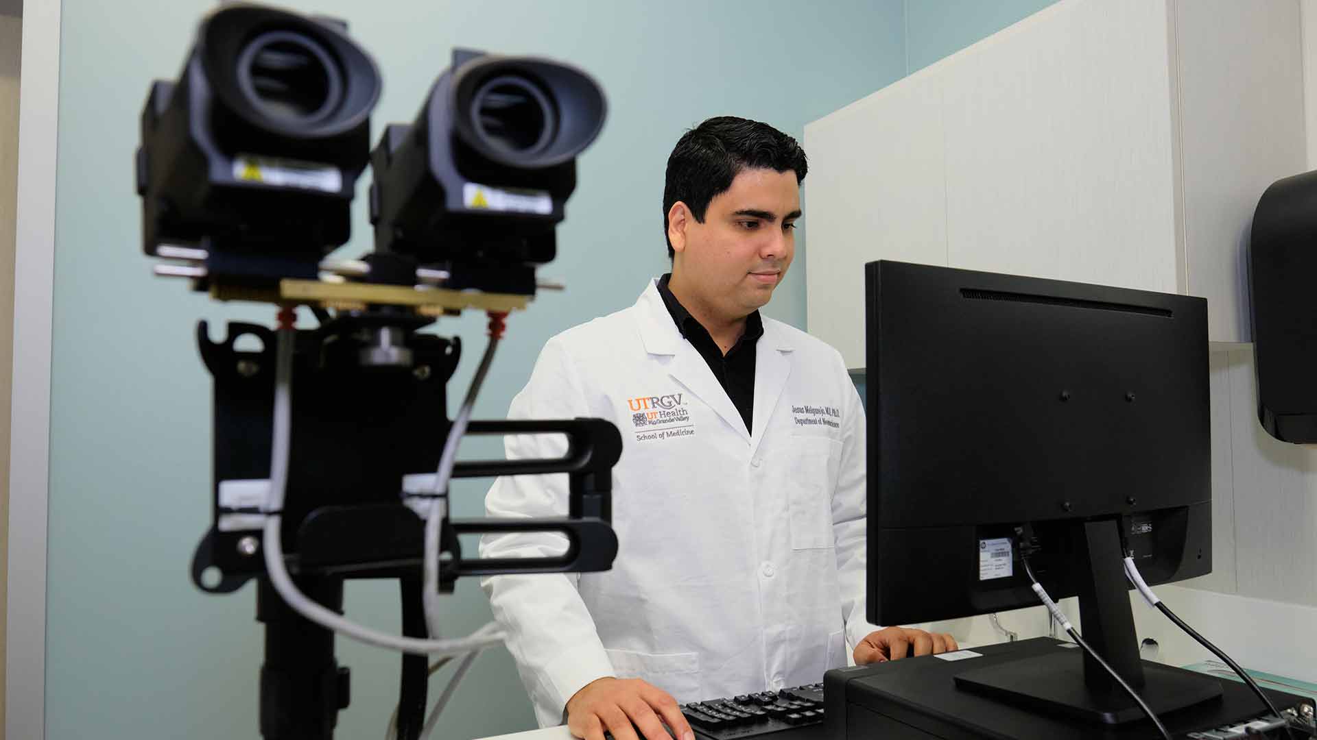 Researcher uses specialized equipment to support Alzheimer's disease assessment and clinical research.