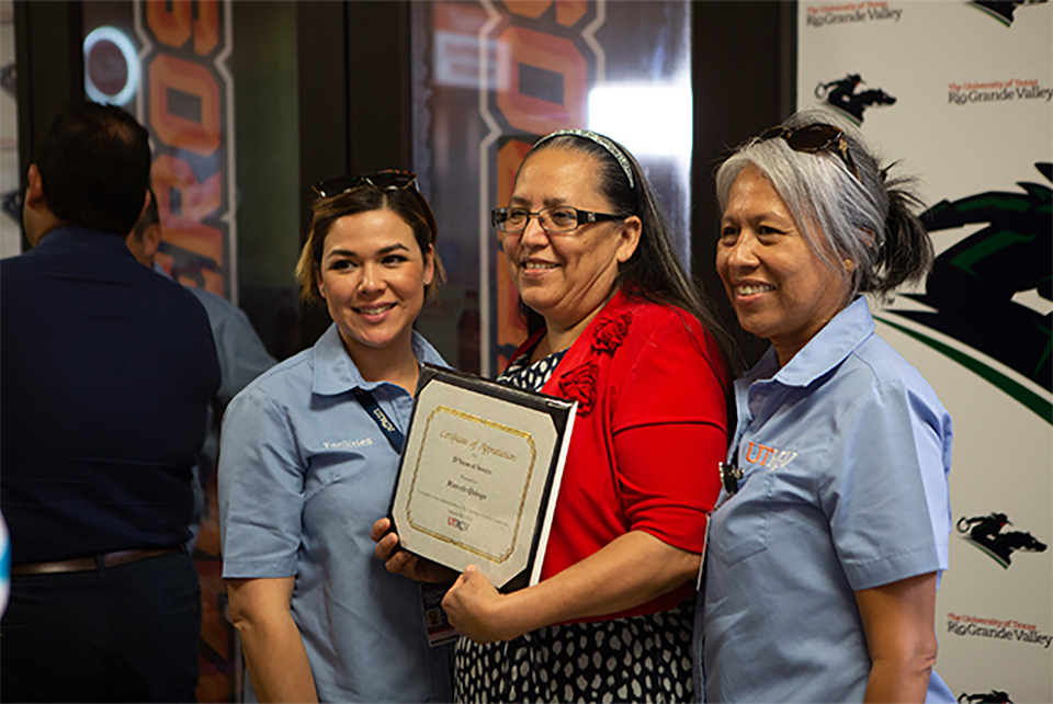 Over 600 staff members were recognized for their years of dedicated service at the first annual UTRGV Staff Service Awards and Recognition ceremonies. The Edinburg ceremony took place at the PlainsCapital Bank Theater in the Student Union on May 15 and on the Brownsville campus at the PlainsCapital Bank El Gran Salón on May 16. Staff members were recognized for their service in increments of five years, starting with 5 years to 40 years as of the transition phase from two legacy institutions to present day UTRGV, up to August 31, 2017. Pictured is Maricela Quiroga (center), from UTRGV’s Campus Facilities Operations, celebrating her 20 years of service with fellow colleagues after the awards ceremony in Edinburg.