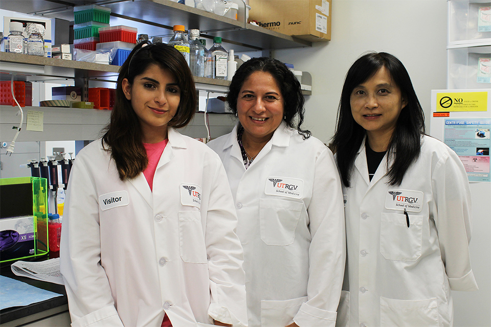 Dr. Sara Reyna, UTRGV assistant professor (at center), has received more than $400,000 from the National Institutes of Health to study the relationship between proteins in white blood cells and inflammation. With Reyna (from left) are Sarai Ramirez, a junior majoring in biology, and research associate Phoebe Fang-Mei Chang. Not pictured is research associate Daniel Acevedo. (Photo by Jennifer L. Berghom)
