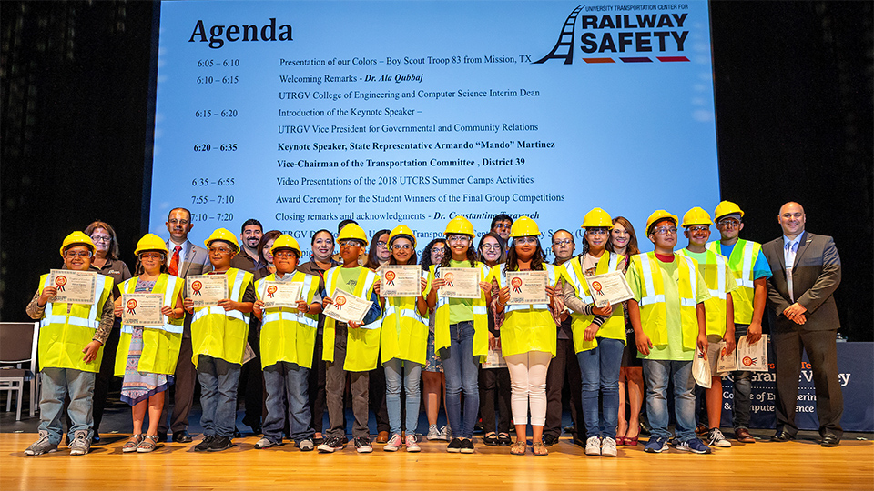 The UTRGV Railway Safety Camp – led by Dr. Constantine Tarawneh (at far right), director of the UTRGV Transportation Center for Railway Safety and associate dean for research and graduate programs in the College of Engineering and Computer Science – is now the largest transportation-related camp in the nation. The program already has expanded to include middle school and elementary students and has reached 5,500 students throughout the Rio Grande Valley. This year, more than 1,200 students from more than 26 local school districts participated in the camp. Students shown here are from the 2018 Railway Safety Camp closing ceremony. (UTRGV Photo by Paul Chouy)