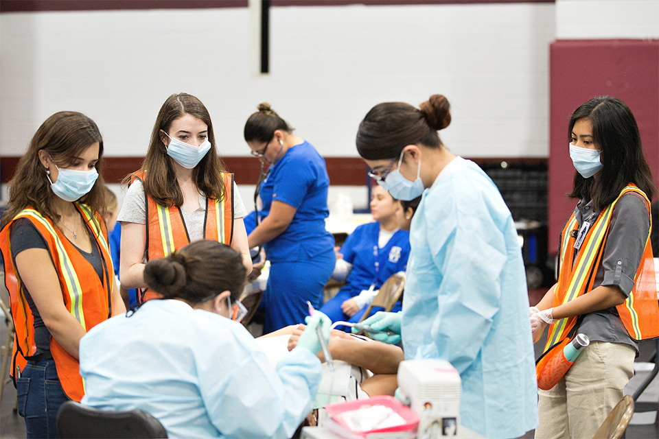 UTRGV family medicine residents and first-year medical students participated recently in Operation Lone Star at Pharr-San Juan-Alamo High School. The annual emergency preparedness event ran from July 23-27, offering public healthcare services for South Texas communities, including physicals, sports physicals, immunizations and screenings for diabetes, blood pressure and vision. Some locations also offered eye and dental exams. The Texas Department of State Health Services runs the weeklong exercise, in partnership with the Texas State Guard Medical Brigade and local health departments. This year, Operation Lone Star conducted the exercises in six locations throughout Cameron, Hidalgo, Starr and Webb counties. (UTRGV Photo by Paul Chouy)