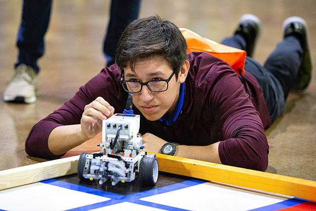 student analyzing robot