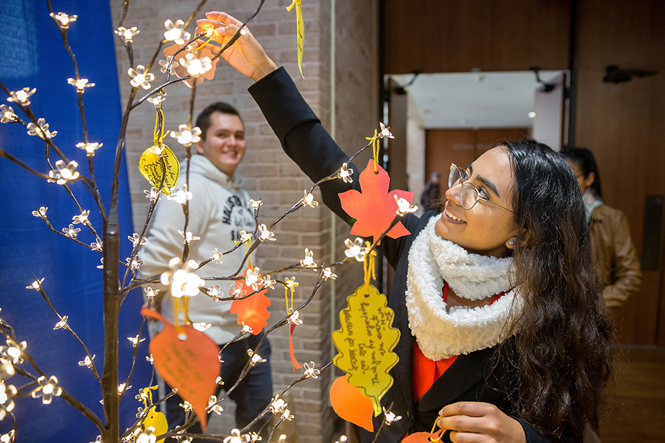 Diana Cano, UTRGV accounting student from Reynosa, Mexico, places a note with a message of what she is thankful for onto a tree during a special Thanksgiving luncheon for UTRGV international students on Monday, Nov. 19, 2018 at the Edinburg Campus. The UTRGV International Admissions & Student Services department hosted the event for international students to experience a traditional Thanksgiving meal with their university family. A luncheon was also held in Brownsville on Nov. 20. (UTRGV Photo by Paul Chouy) 