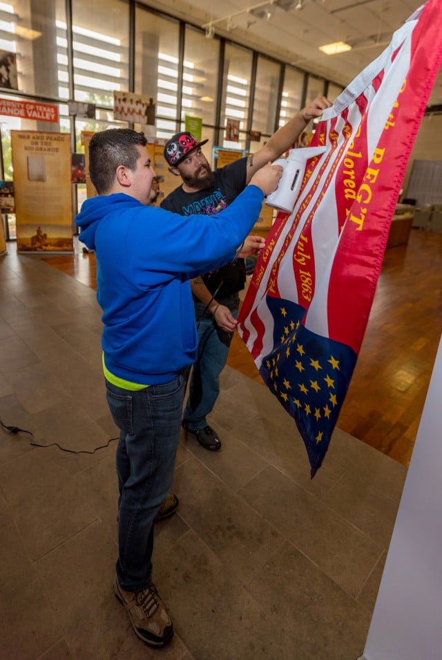 Two UTRGV students iron out one of the flags for display in the traveling Civil War exhibit.