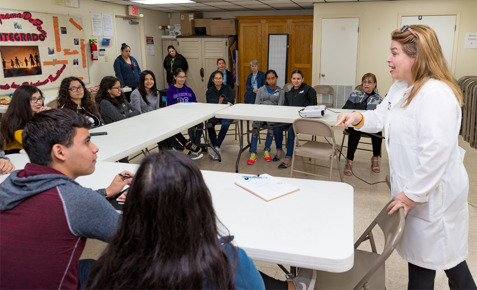 Dr. Gladys Maestre (standing, at right), a UTRGV professor of neuroscience and human genetics and director of the UTRGV Alzheimer´s Disease Resource Center for Minority Aging Research, is seen here working with a group of high school students known as the center’s Alzheimer’s Ambassadors. The center provides education, mentoring and support for the ambassadors, Maestre said, so they can go to events and into the community to become the voice of people with Alzheimer’s and their caregivers. (UTRGV Photo by David Pike)