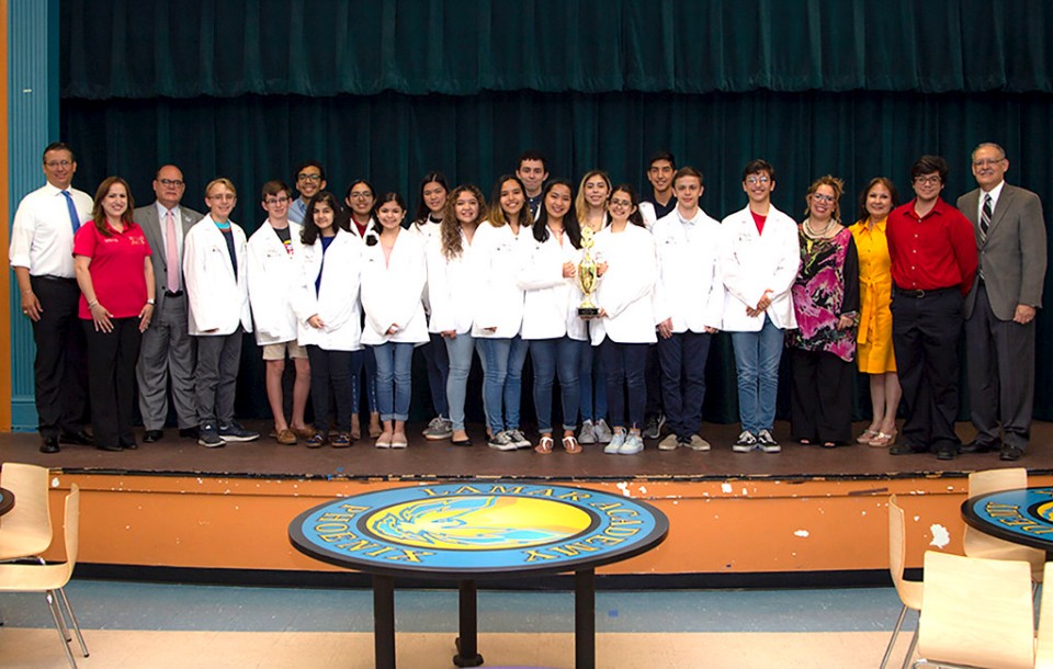 Lamar Academy students wearing white coats in McAllen.