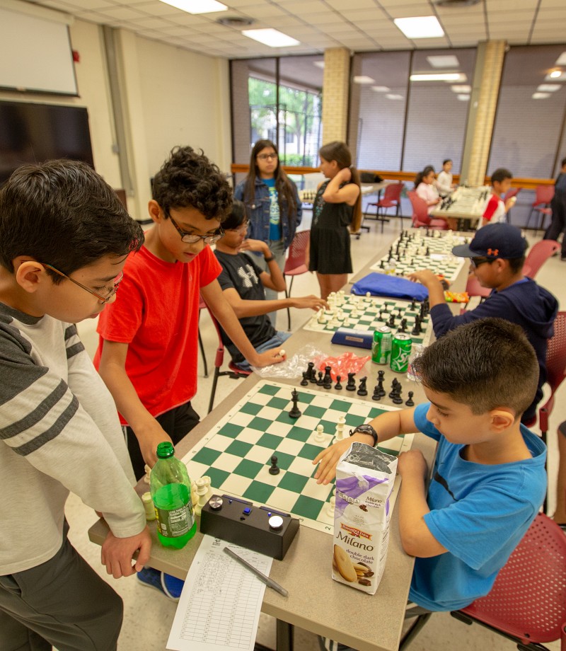 Children compete against each other in chess game.