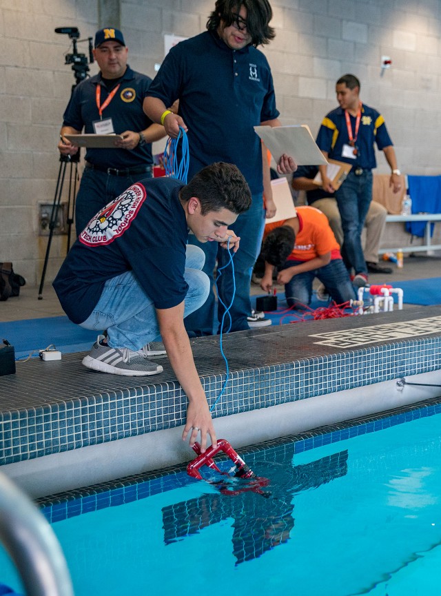 Students place their ROV in the water during the 2020 SeaPerch Challenge