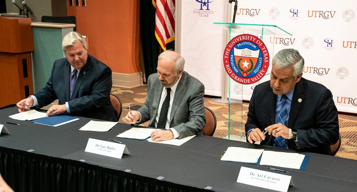 Harlingen Mayor Chris Boswell, UTRGV President Guy Bailey, and Harlingen CISD Superintendent Art Cavazos signing agreements