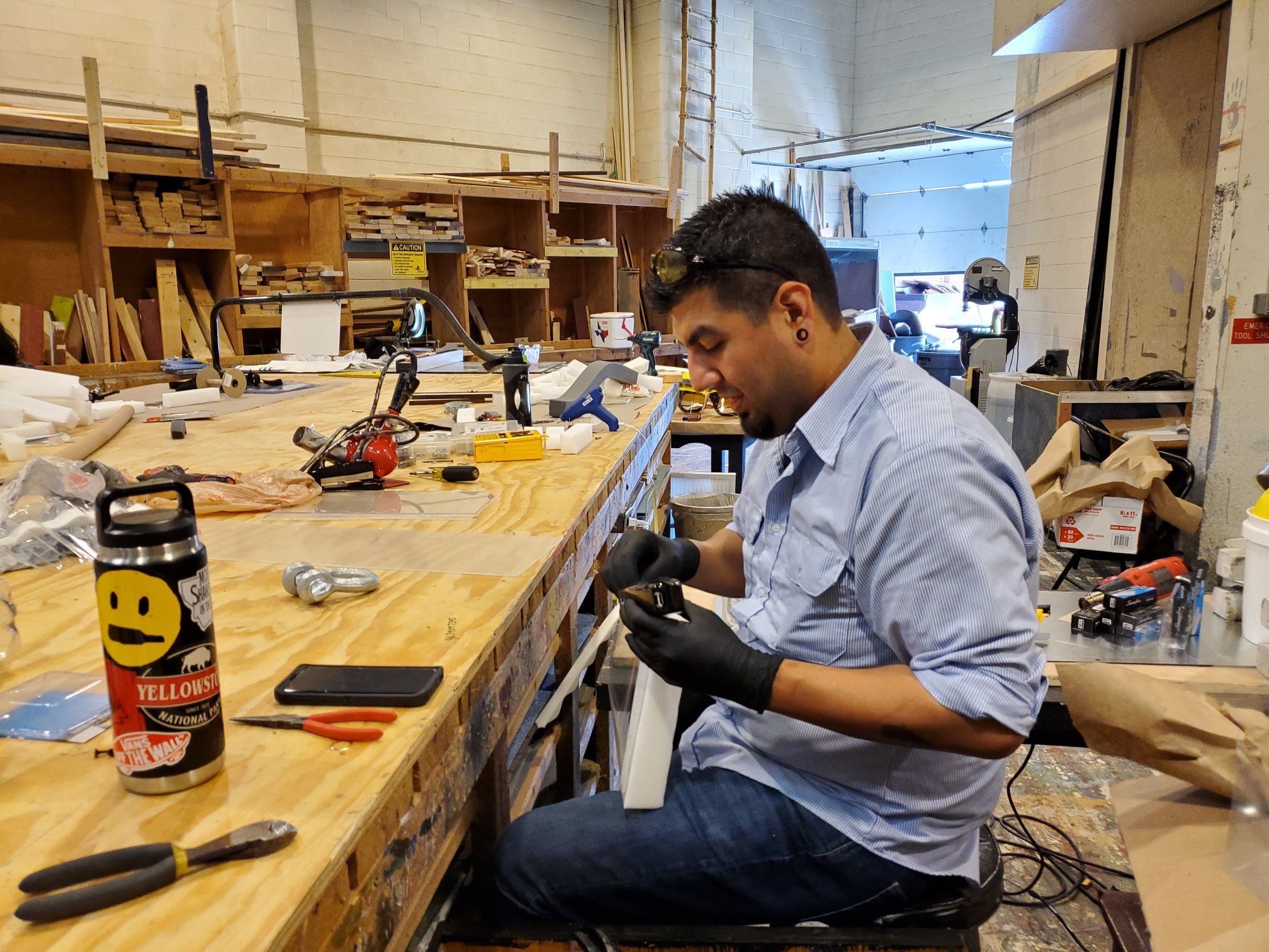 Eric Sanchez, student, assembling a face mask.