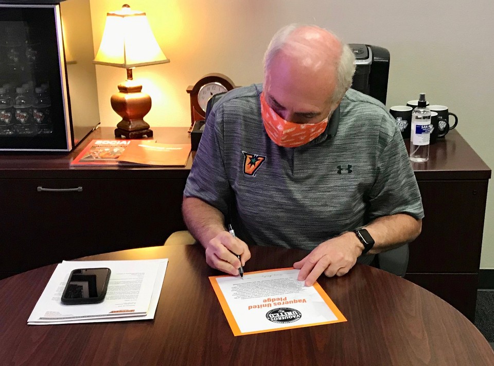 UTRGV President Guy Bailey signs the Vaqueros United Pledge