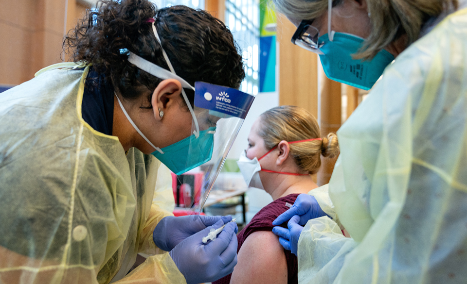 Dr. Linda Nelson (right), a Doctor of Nurse Practice (DNP), RN, pediatric nurse practitioner and senior director of Clinical Operations for the UTRGV School of Medicine and UT Health RGV, instructs Brownsville native Clarissa Chavez, a second-year physician assistant studies student at UTRGV, on how to administer the COVID-19 vaccine on Monday, Dec. 21, at the Medical Education Building in Edinburg. (UTRGV Photo by Paul Chouy)