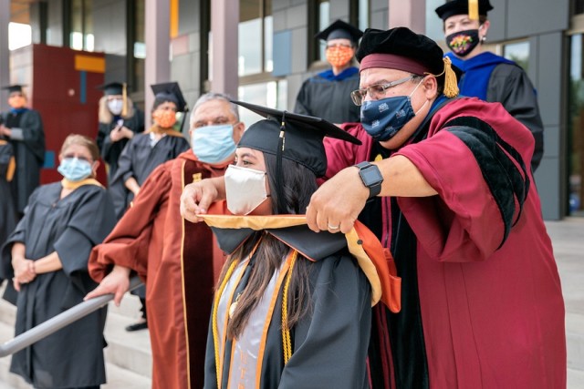 Dr. Luis Torres-Hostos and student graduate