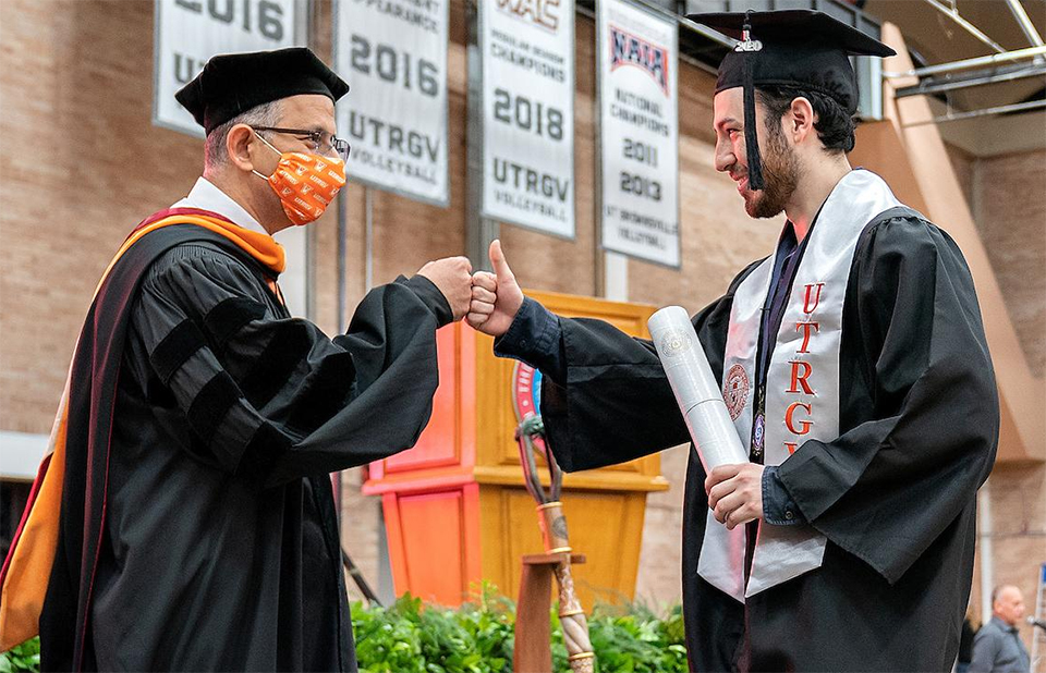 Dr. Ala Qubbaj, dean for the College of Engineering and Computer Science, congratulates one of his college graduates during the Friday ceremonies in Edinburg. (UTRGV Photo by Paul Chouy)