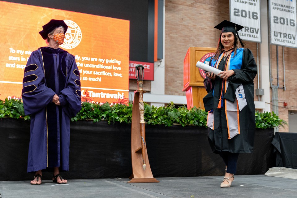 Dr. Linda Matthews and COBE graduate on stage