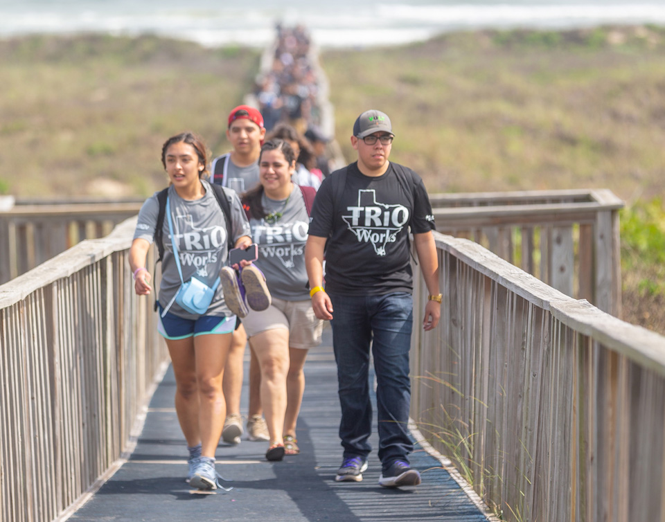 UTRGV TRIO Students walking over a dunes bridge