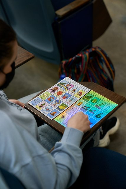 Young woman plays two loteria cards