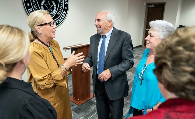 UTRGV President Guy Bailey chats with the family of Jon and Elizabeth Burkhart during a press conference