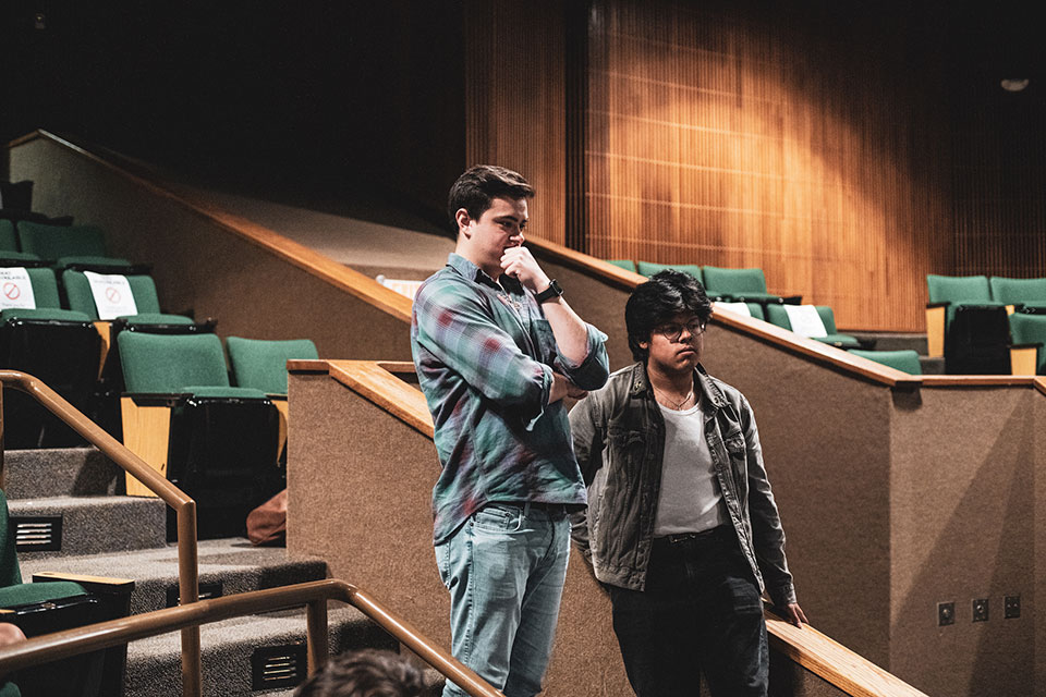 Behind the production, reviewing the final details of the play.