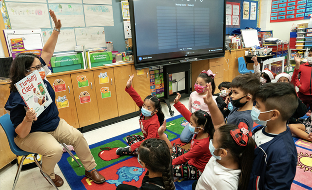 Dr. Doris Mendiola, UTRGV director of Community Engagement, talks to students at Roosevelt Elementary School in McAllen on Dec. 14 as part of the literacy promotion event organized by the UTRGV Office of Community Engagement and UTRGV Staff Senate. (UTRGV Photo by Paul Chouy)