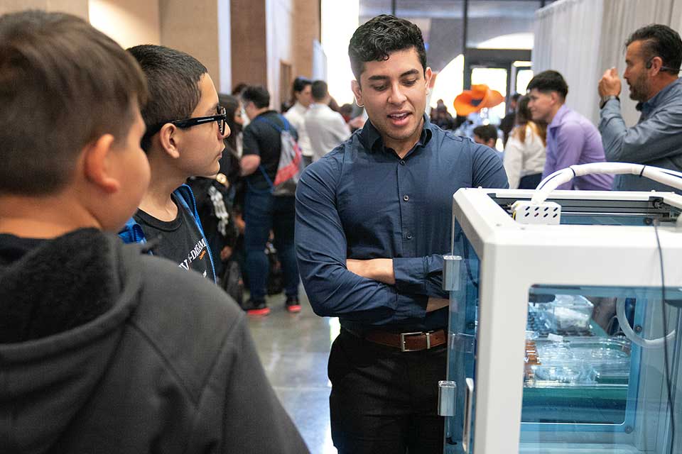 UTRGV student showcases project in front of younger crowd.