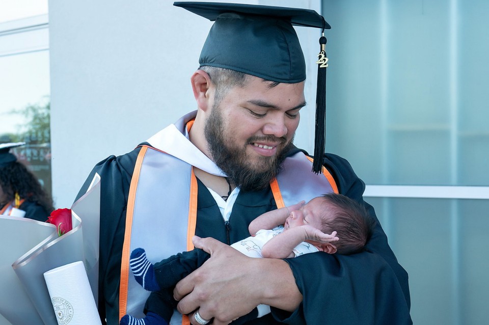UTRGV graduate holding baby