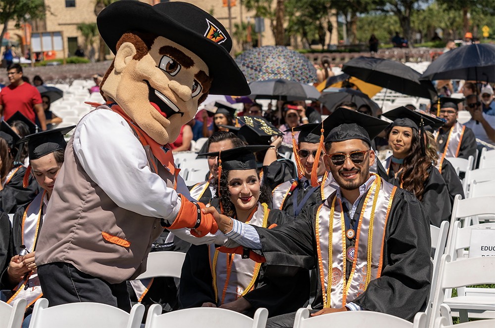 The UTRGV Vaquero mascot enjoyed the festivities and congratulated a graduate before the start of the 4 p.m. Brownsville ceremony. More than 600 graduates participated in the Friday ceremonies. (UTRGV Photo by David Pike)