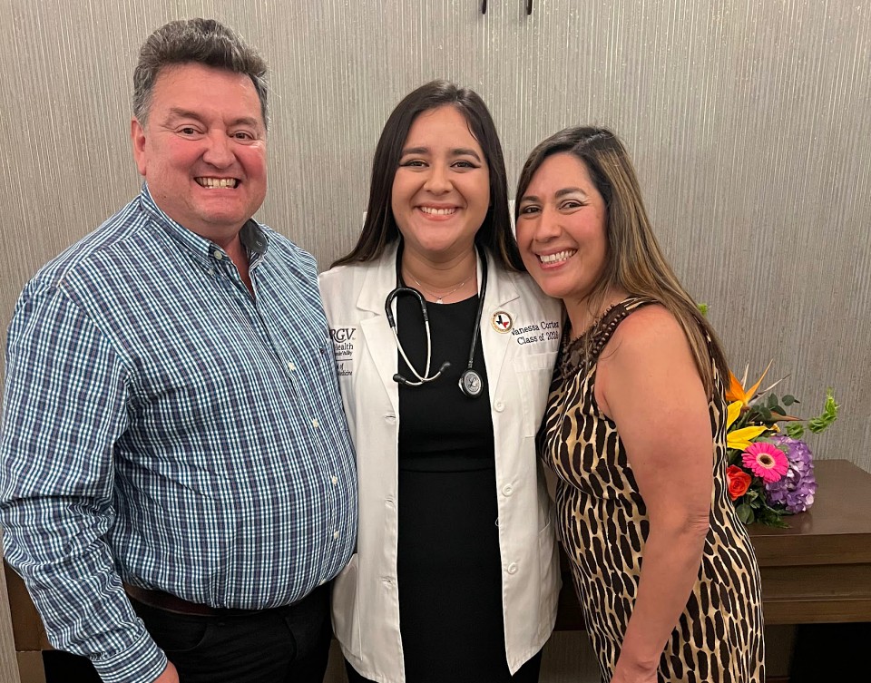 Vanessa Cortez, a member of the first class of the UTRGV School of Podiatric Medicine, stands proudly with her mother and father. She aspires to make them proud by blazing a trail for her siblings.