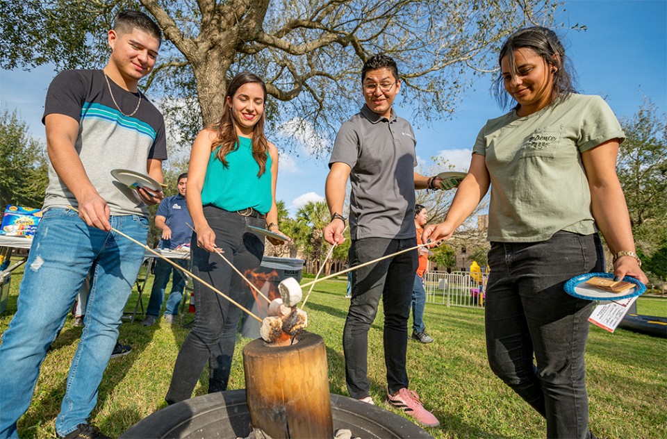 Students roast marshmallows for s'mores during Welcome Week activities in 2020.