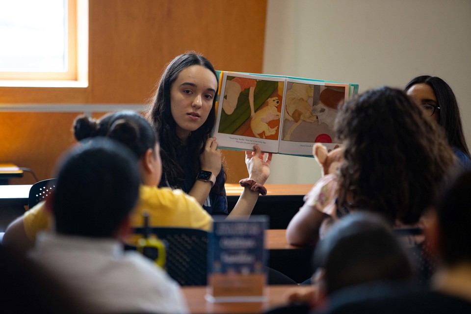 Young woman reading stories to children