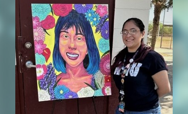 Brownsville artist Gracie Rodriguez stands next to her artwork during a UT Health RGV Pachanga event